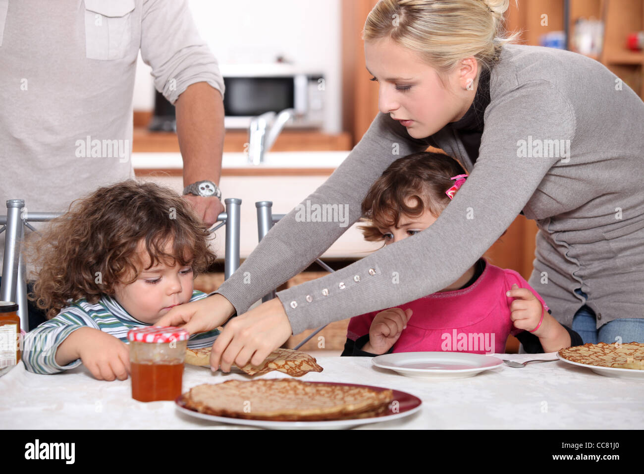 Children eating crepes Stock Photo