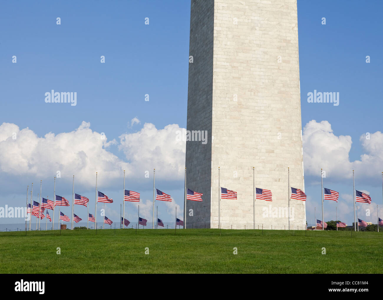 Row of American flags flying half staff at the Washington Monument