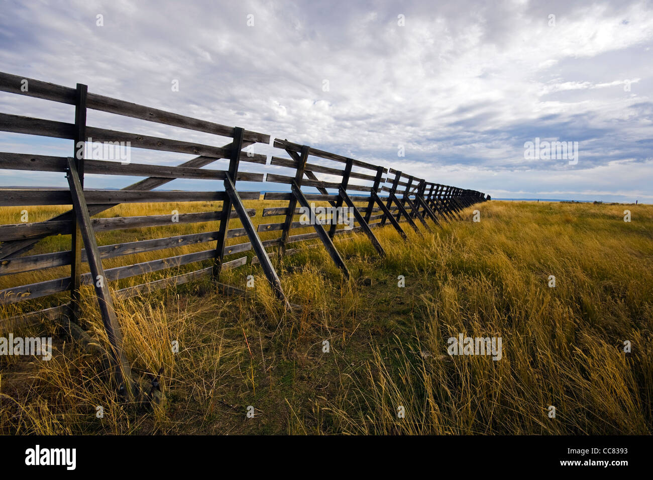 Wooden snow fence on the prairie to stop drifting snow from piling up on the state’s windswept highways in Wyoming in winter, US Stock Photo