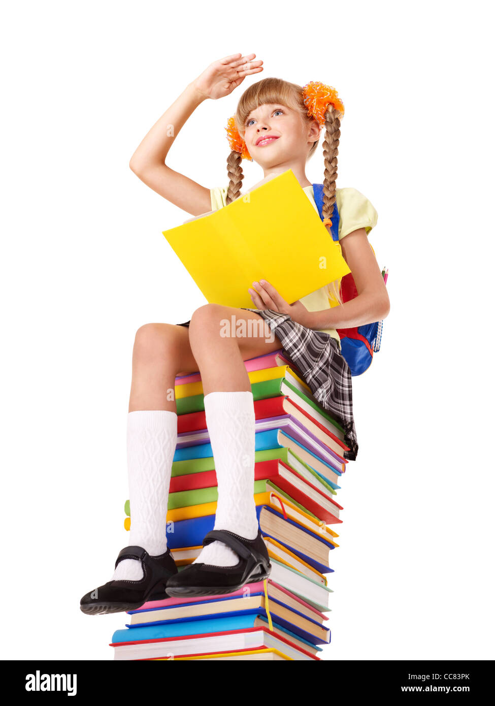 Schoolgirl sitting on pile of books Stock Photo - Alamy