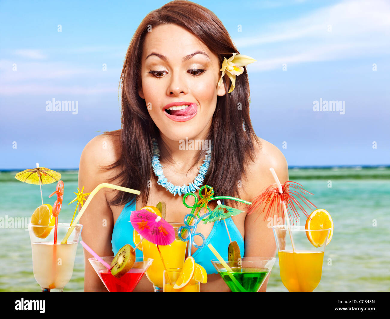 Girl in bikini drink juice on beach Stock Photo Alamy