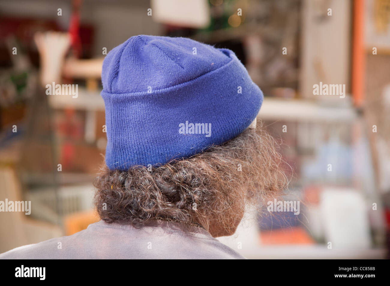 Man with blue wool pull-on hat and straggly unkempt hair Stock Photo