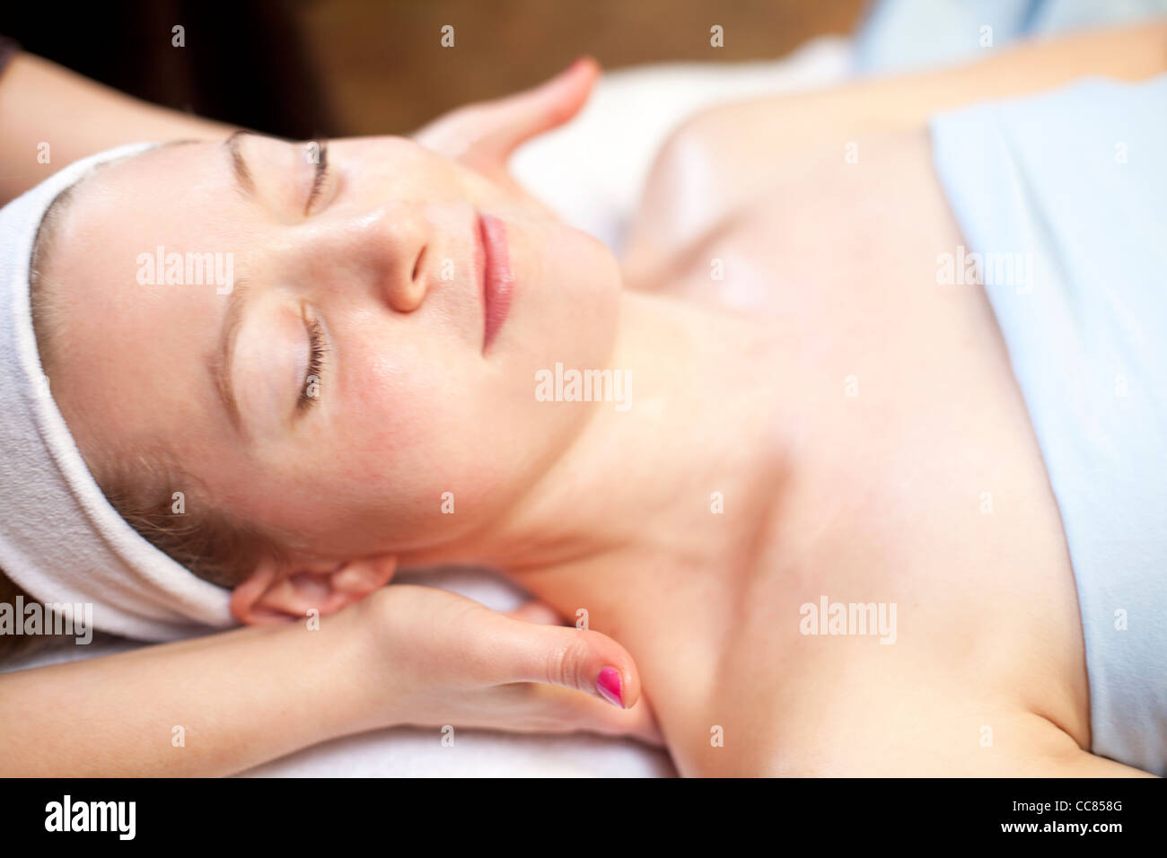 young woman receiving a back massage. Stock Photo