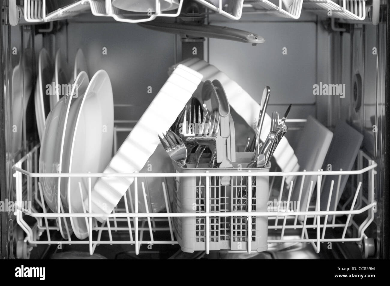 A dishwasher with lots of dishes and glasses Stock Photo