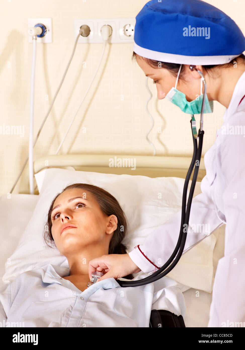 Doctor treats female patient with stethoscope Stock Photo - Alamy