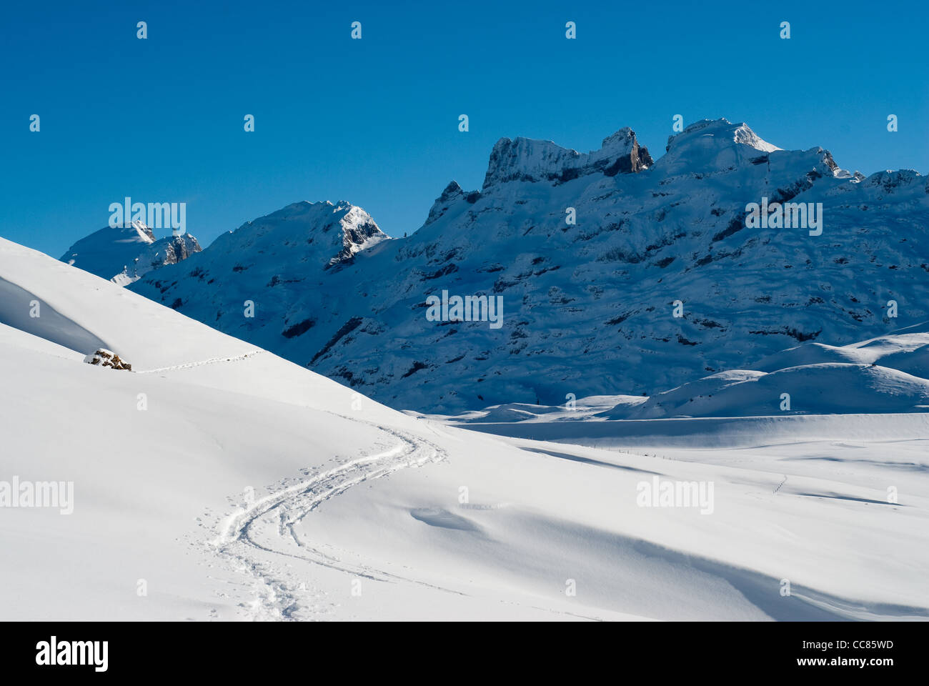 snowtrail and winter mountain range at melchseefrut, switzerland Stock Photo