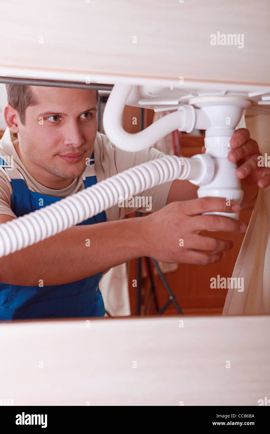 Plumber installing a sink Stock Photo Alamy