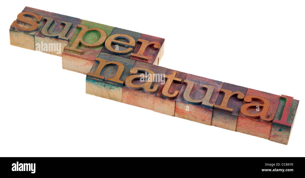 supernatural word in vintage letterpress printing blocks, stained by color inks, isolated on white Stock Photo
