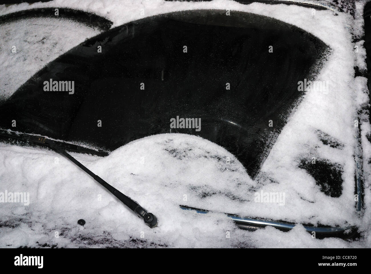 car windshield with snow and windscreen wiper at night Stock Photo Alamy