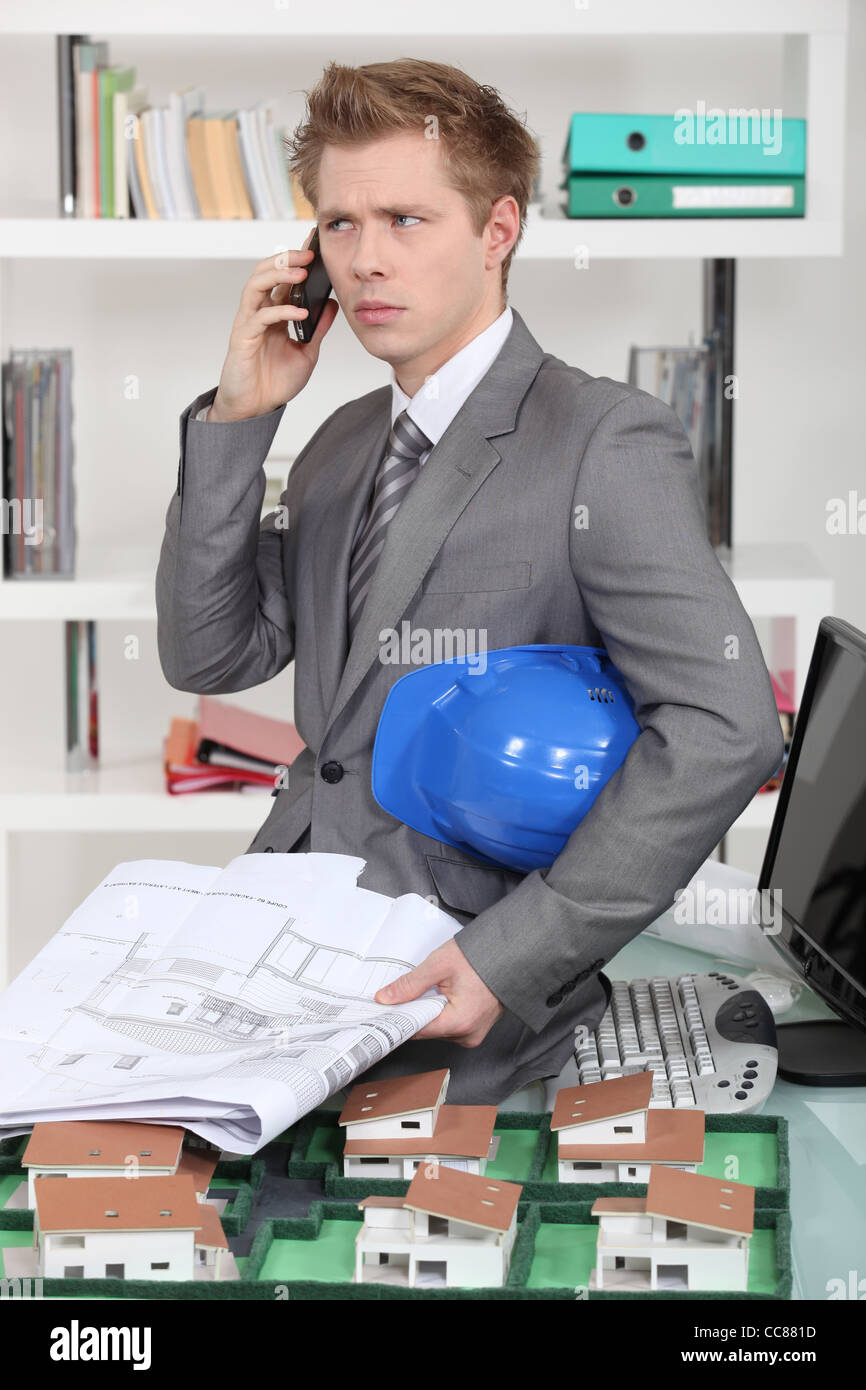An annoyed architect talking on the phone Stock Photo