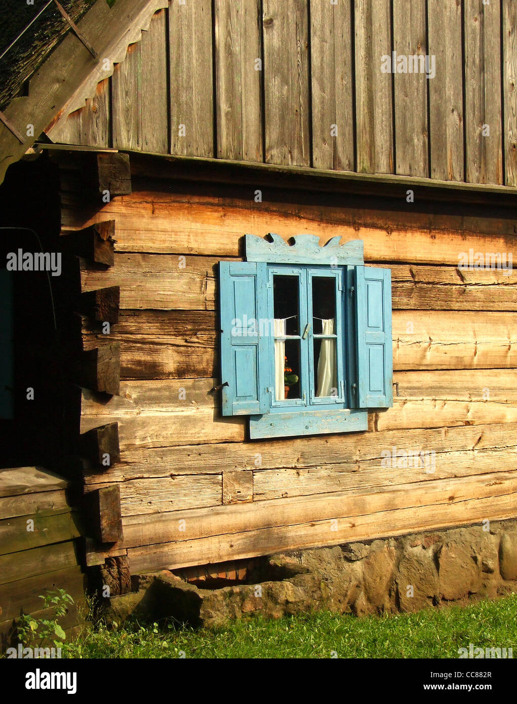 Old wooden wall with blue window Stock Photo - Alamy