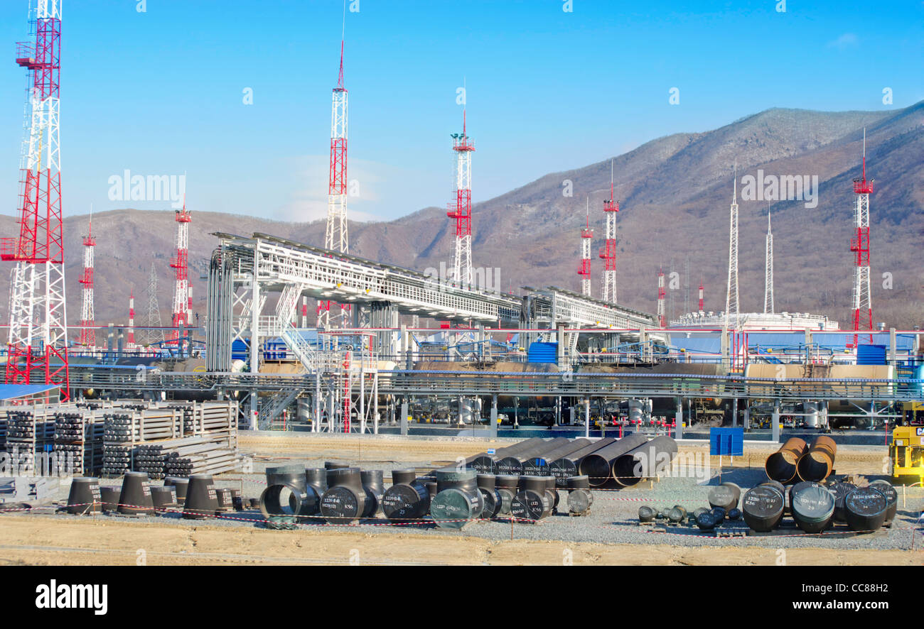 Overload of oil from the pipeline in railway tanks against mountains Stock Photo