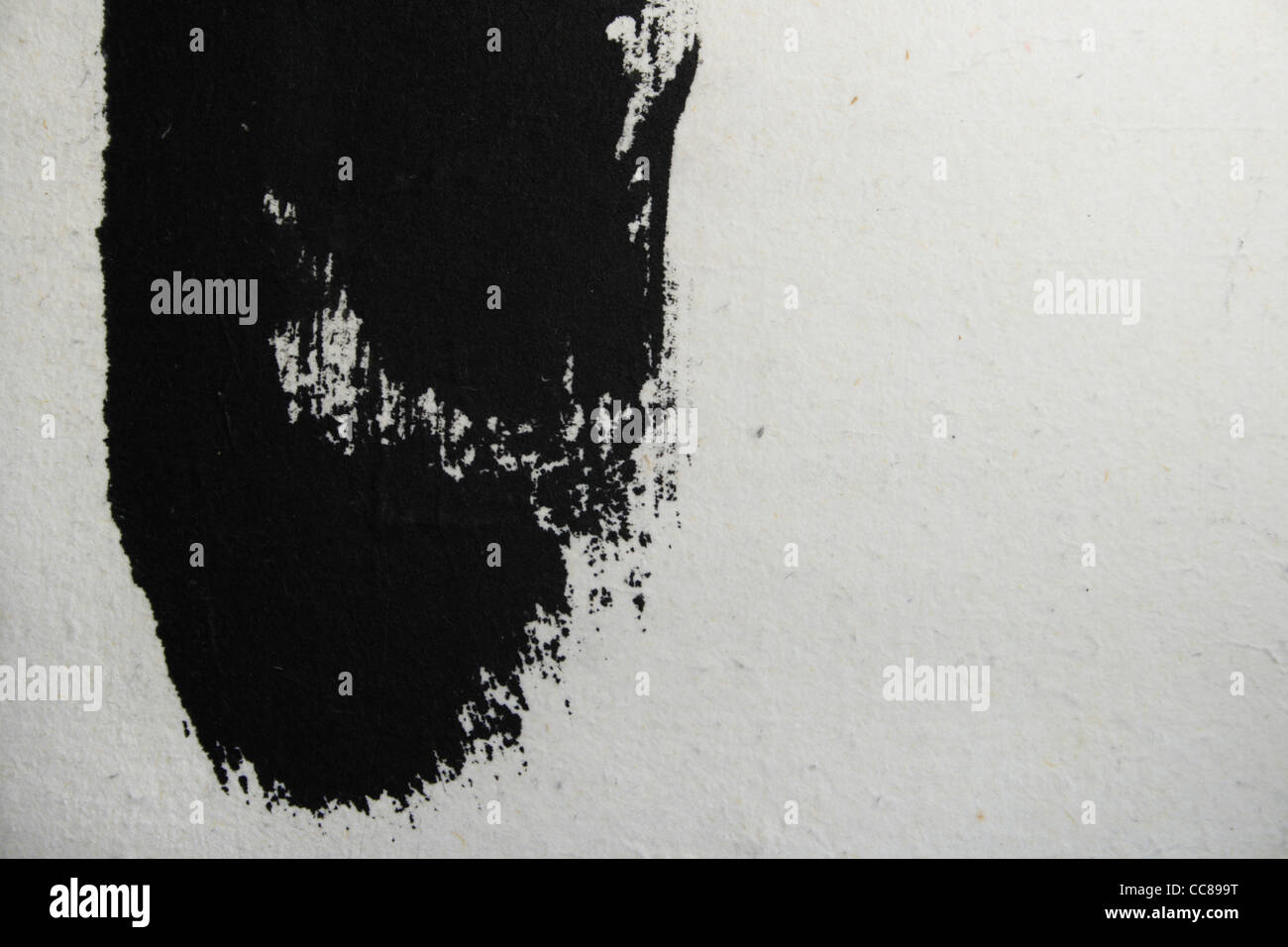 grunge style black painted streak on white paper with copy space Stock Photo