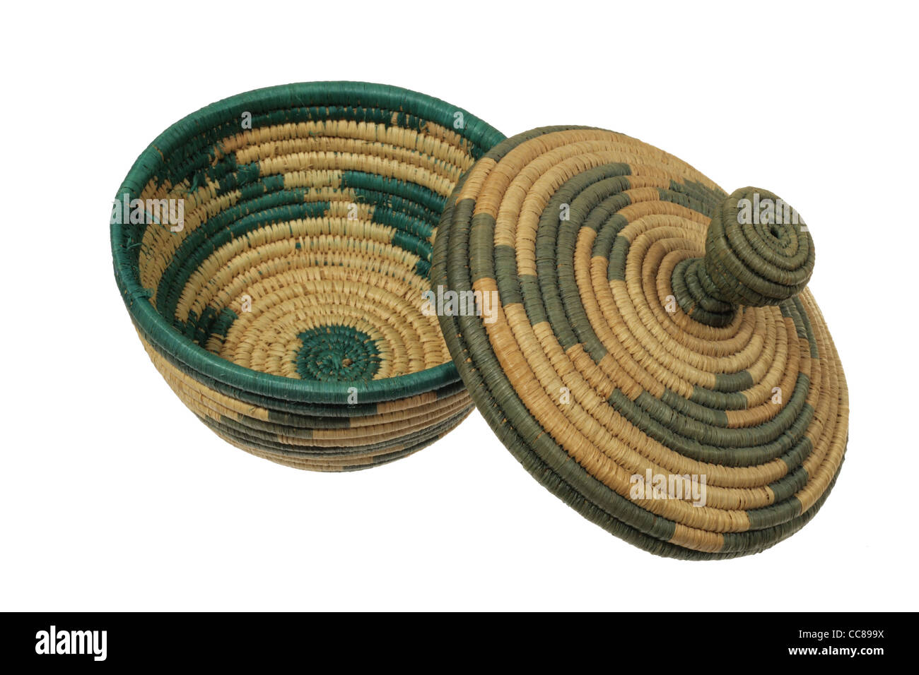 faded green and tan African basket with lid isolated on a white background Stock Photo