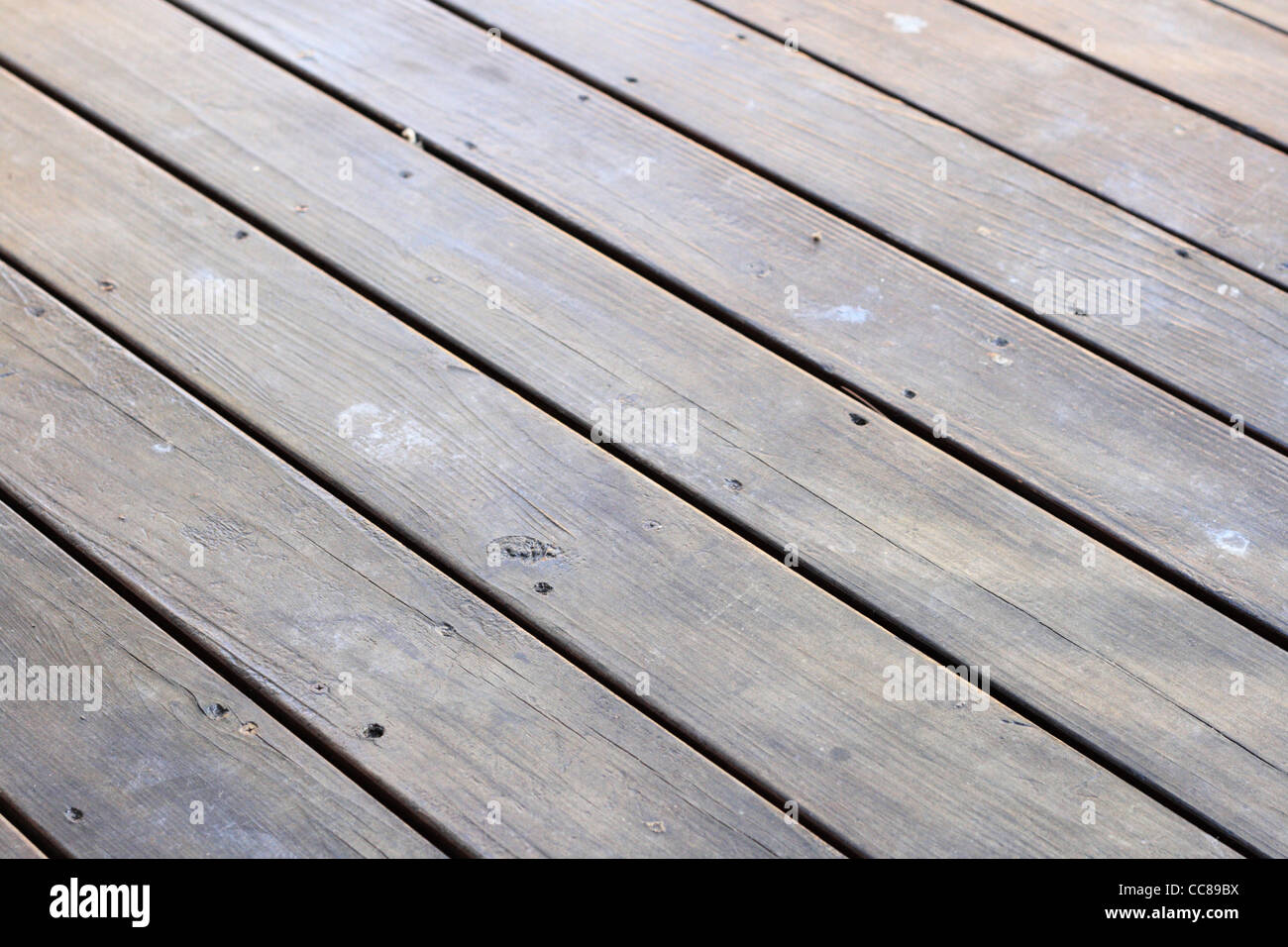 dark cracked wooden deck surface with screwed Stock Photo