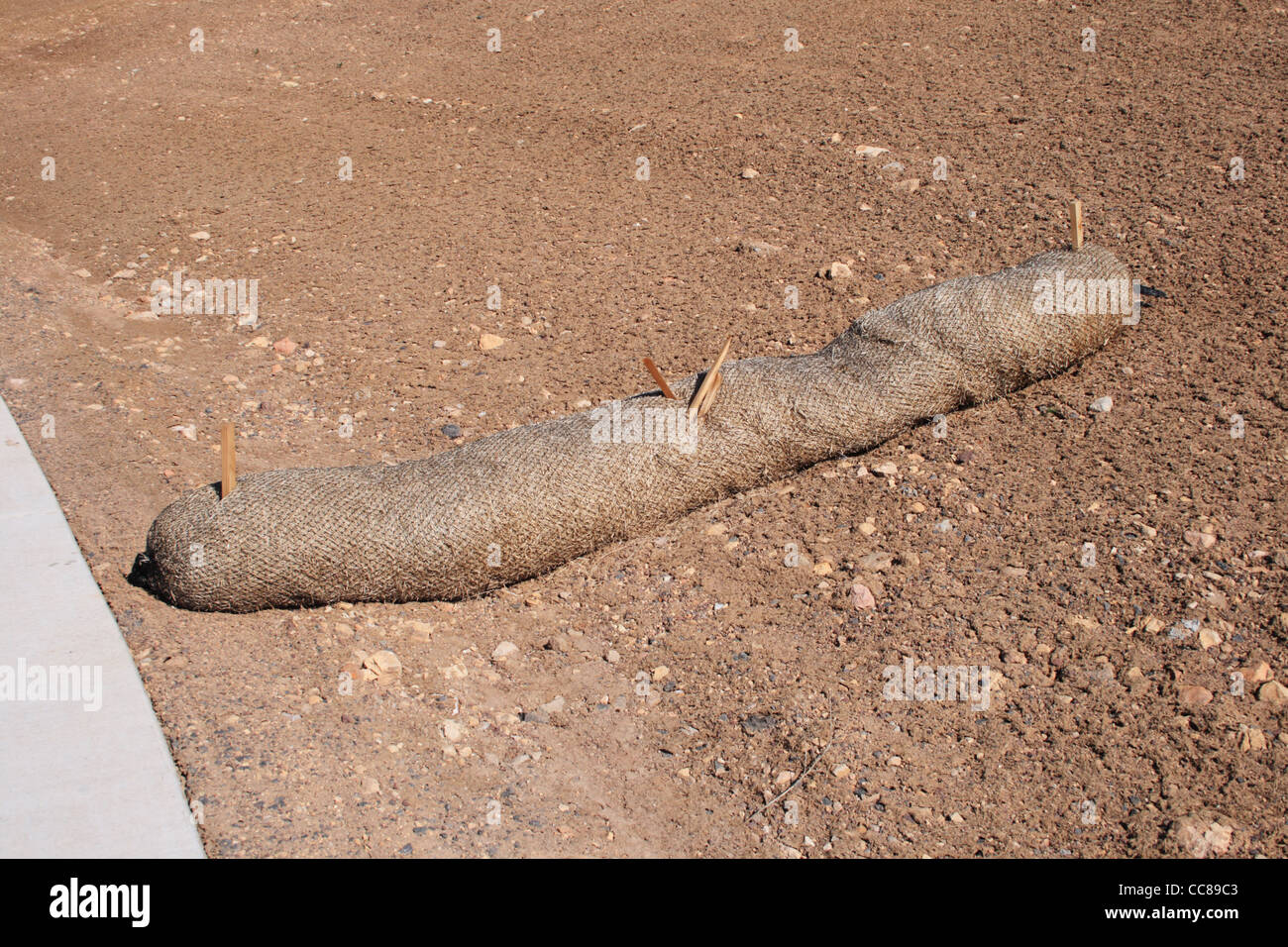 straw wattle erosion control structure protects soil and runoff at construction site Stock Photo