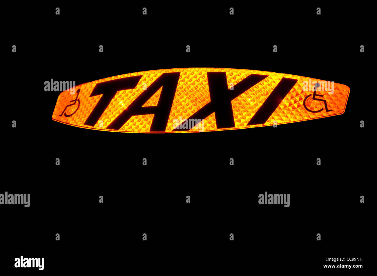 Illuminated Taxi sign showing the word Taxi and a disabled symbol to show a wheelchair accessible vehicle Stock Photo