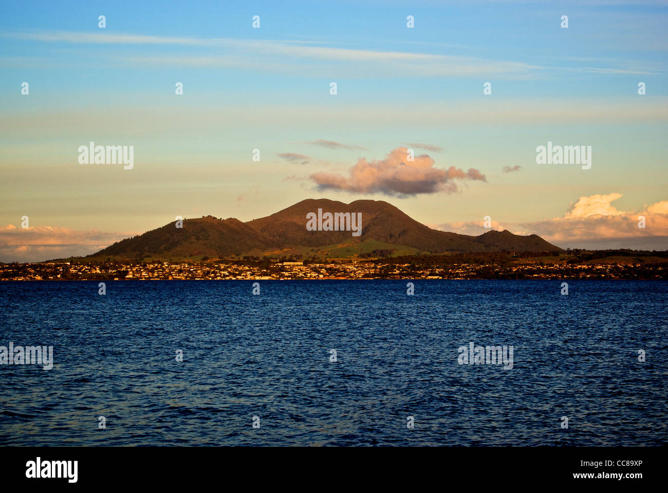 Extinct volcano cinder cone on shores of Great Lake Taupo New Zealand at sunset Stock Photo