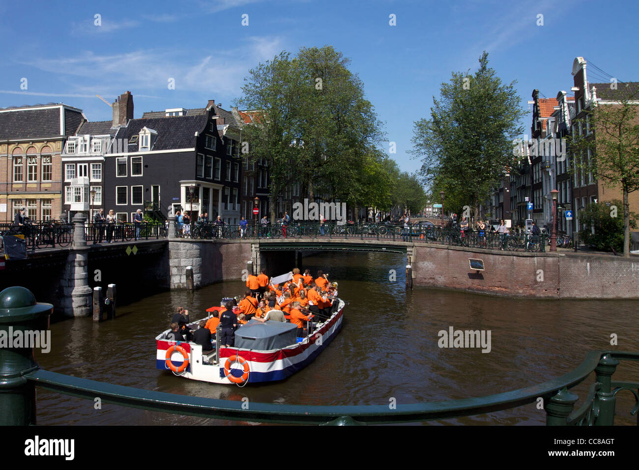 Boat along canal in Amsterdam Stock Photo