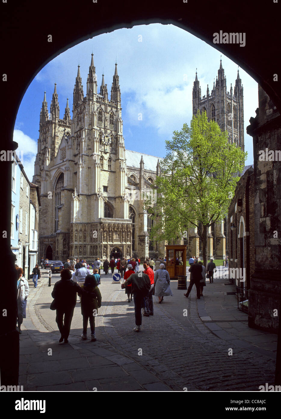 Canterbury Cathedral view framed by arch people visiting this part of the World Heritage Site & Grade I listed architecture in sunny Kent England UK Stock Photo
