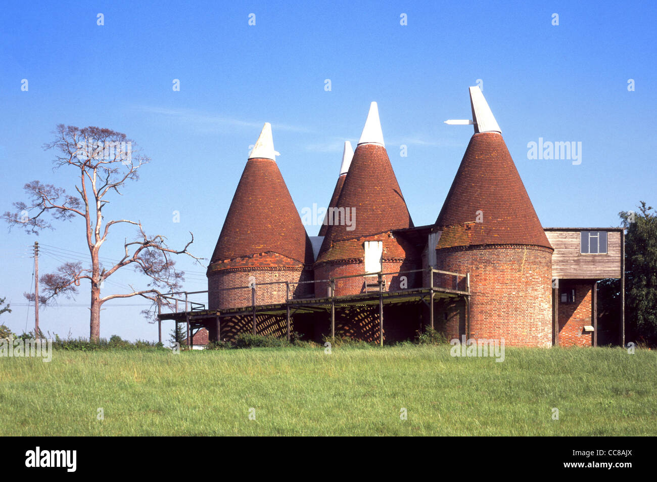 Historical building Oast house used for kiln drying of hops in beer brewing now nostalgic heritage feature of Weald of Kent English countryside UK Stock Photo
