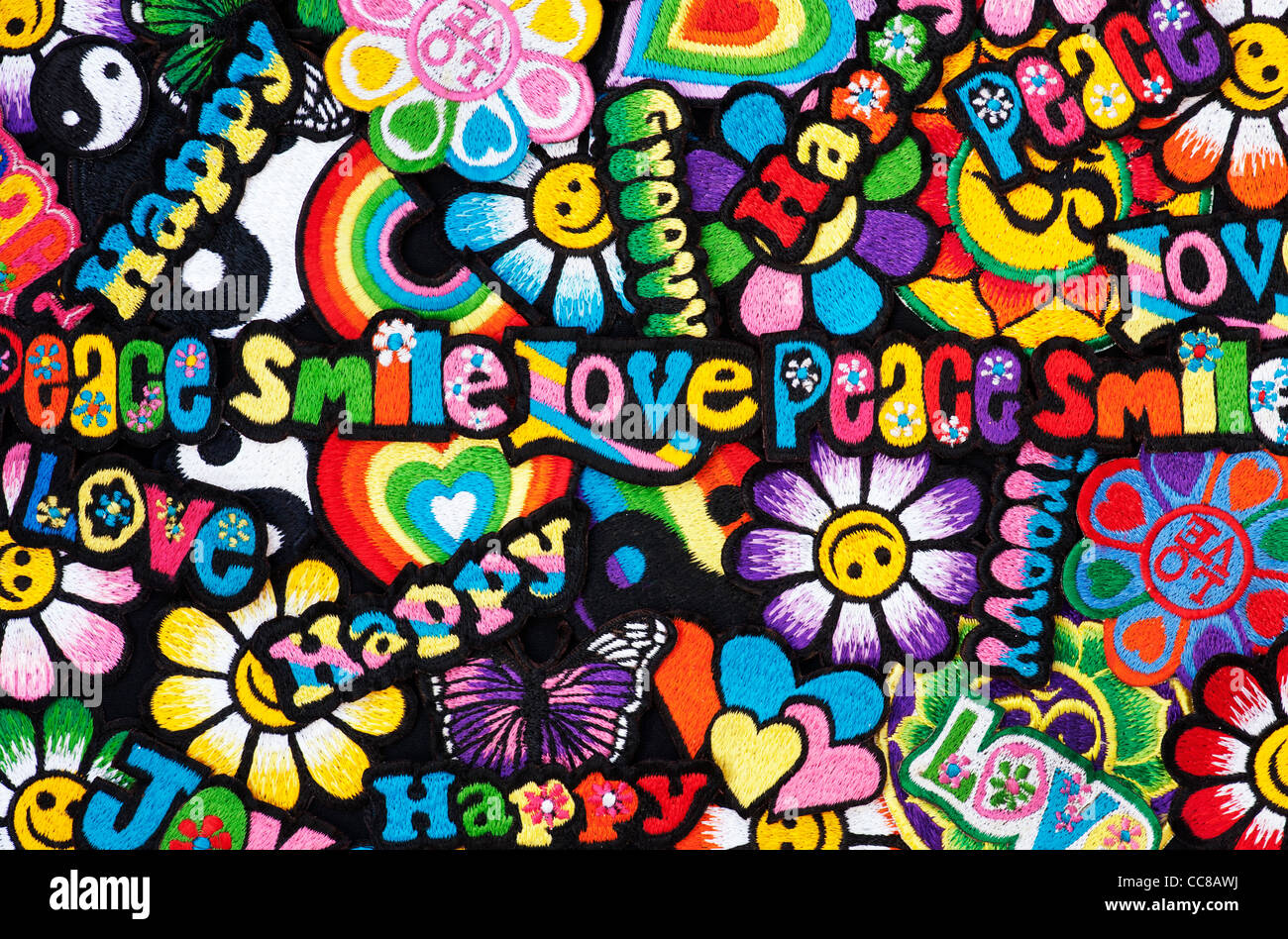 Embroidery iron on patches of Multicoloured Love, Peace, Happy, Smile, Joy and Groovy words on a black background Stock Photo