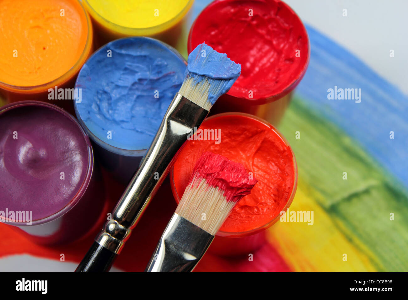 Paint brushes with opened paint buckets Stock Photo