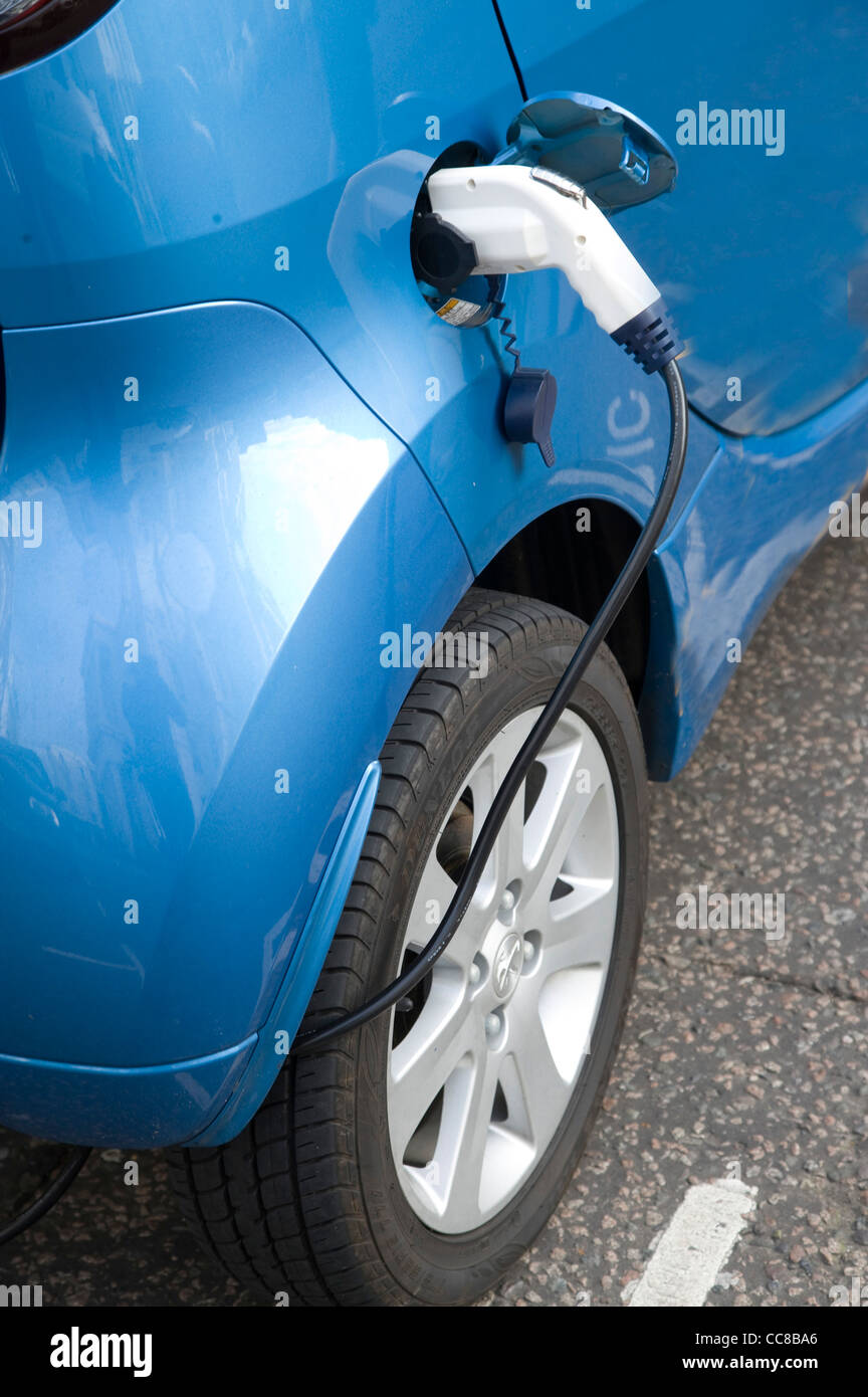 An electric car charging batteries at roadside service port Stock Photo