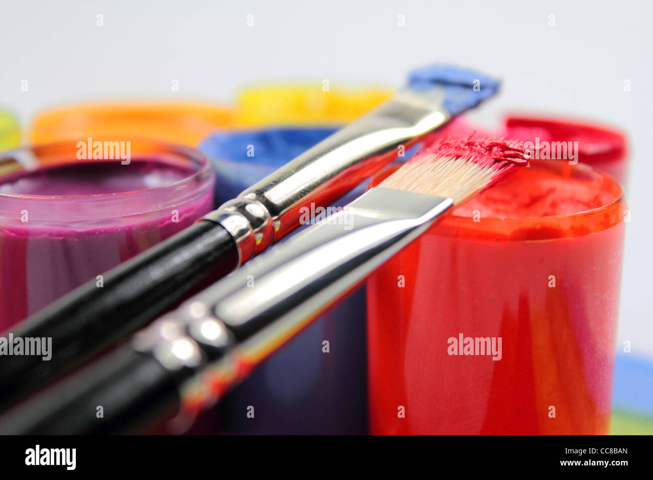 Paint brushes on paint buckets Stock Photo Alamy