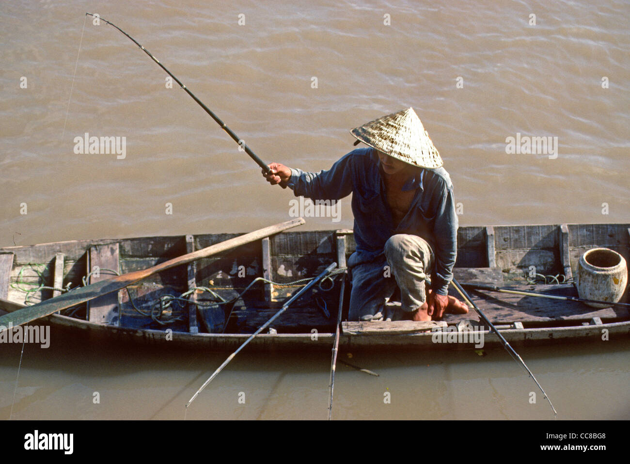Fisherman fishing from boat Mekong Delta Vietnam Stock Photo - Alamy