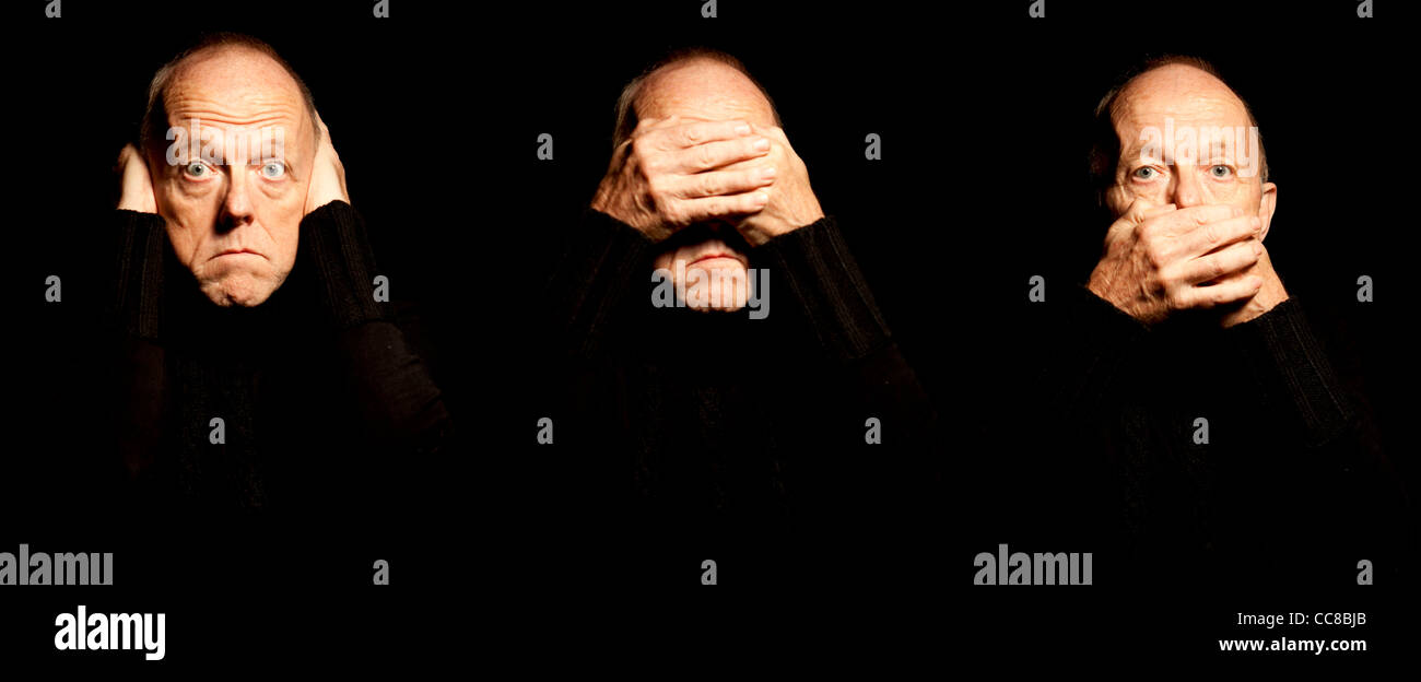 Man in 3 poses representing hear no evil, see no evil, speak no evil.  All 3 images merged together set against black background Stock Photo