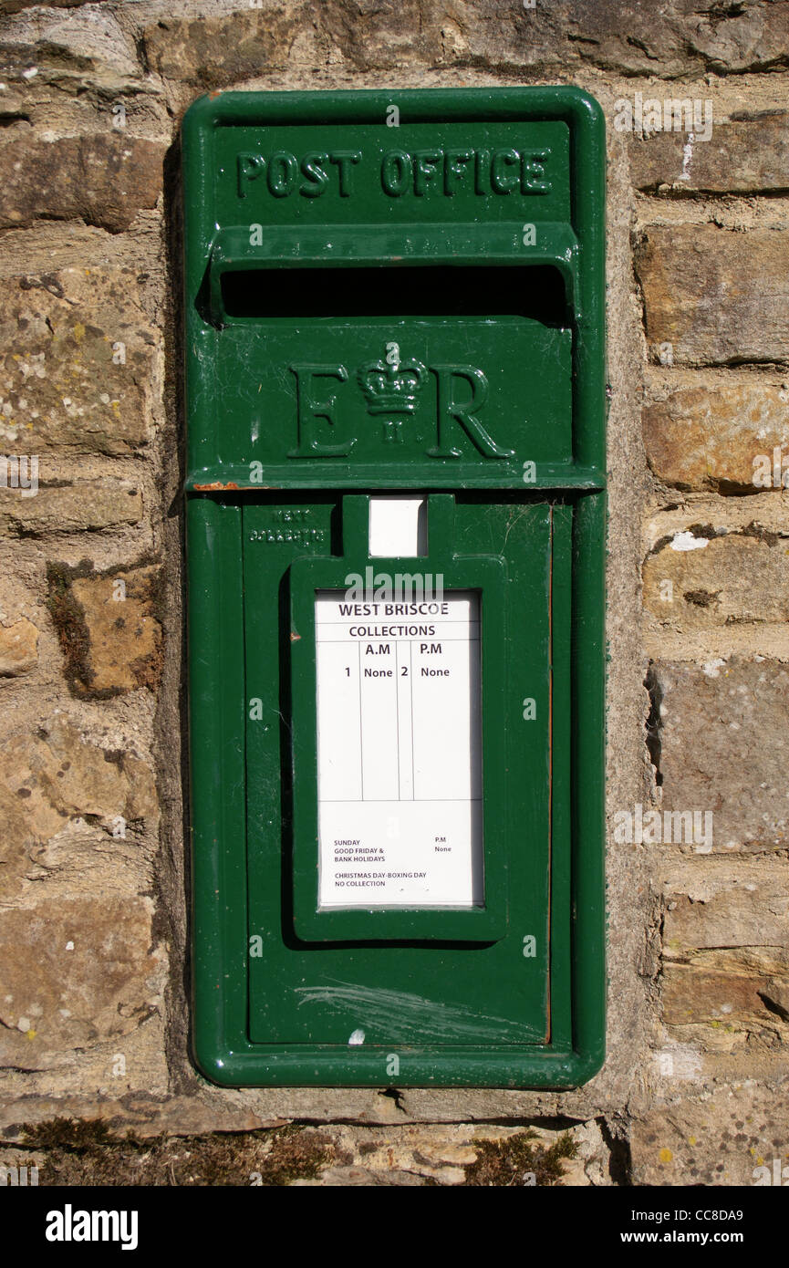 A disused green letterbox on a farm wall, Baldersdale, County Durham, England Stock Photo