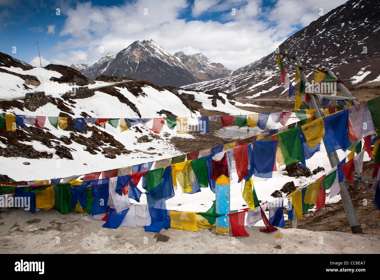 India, Arunachal Pradesh, Sela Pass, prayer flags flying beside road to Tawang Stock Photo