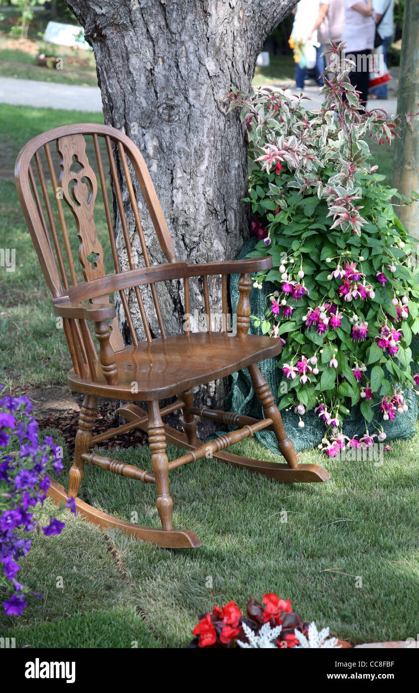 Rocking chair and flowers Stock Photo - Alamy