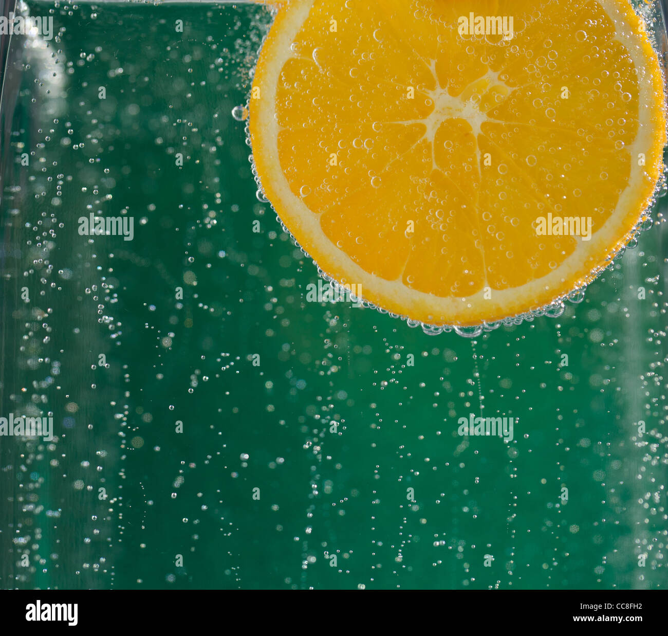 Orange wedge in sparkling water Stock Photo