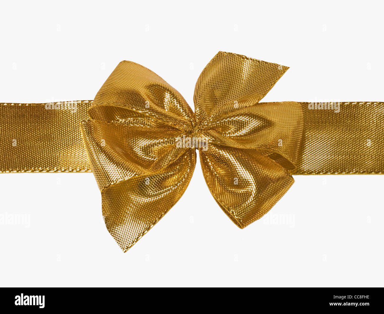 Detailansicht einer goldenen Schleife, waagerecht | Detail photo of a golden bow, horizontally Stock Photo