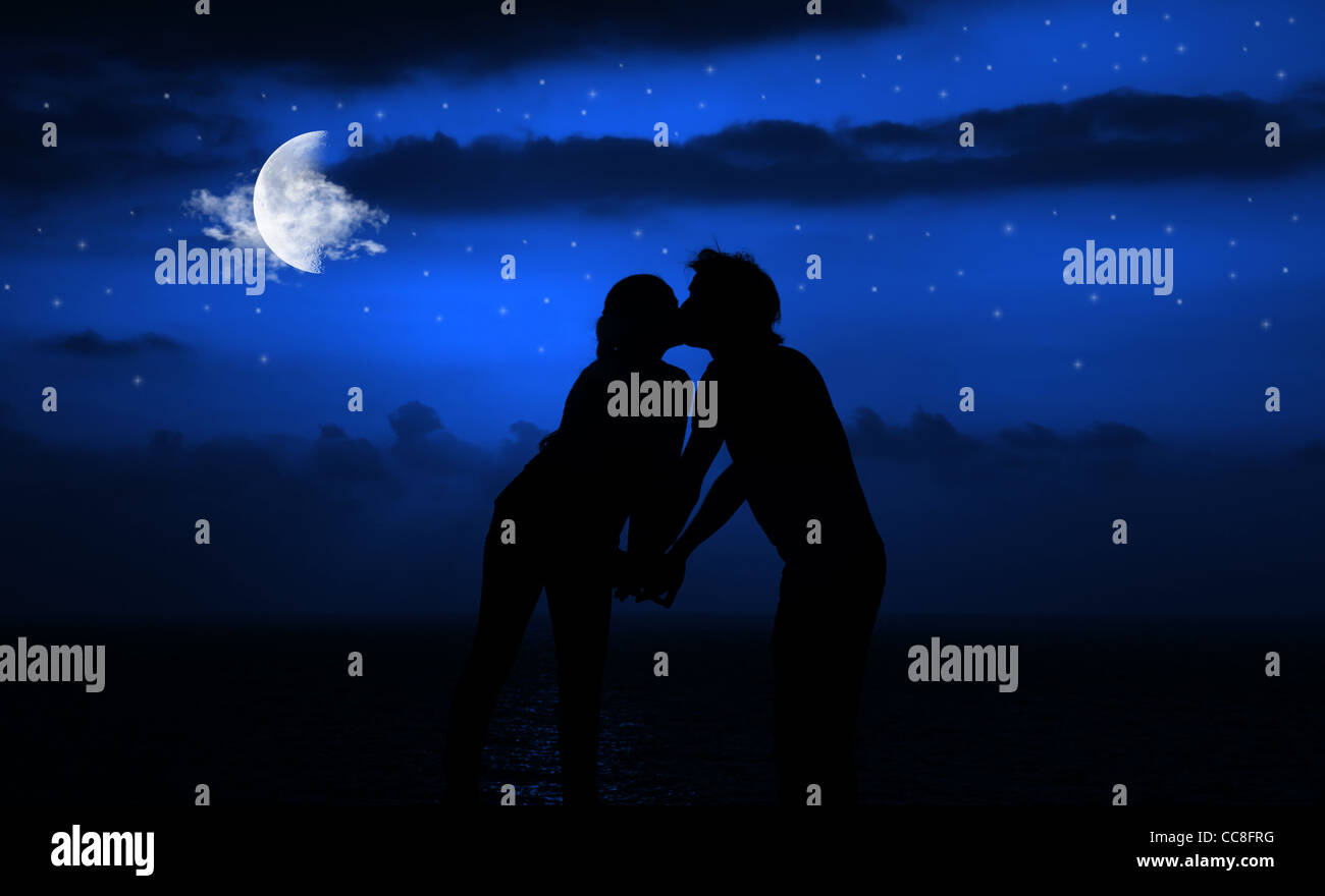 Happy Couple Romantically Kissing At Night Under Moonlight Stock Photo Alamy