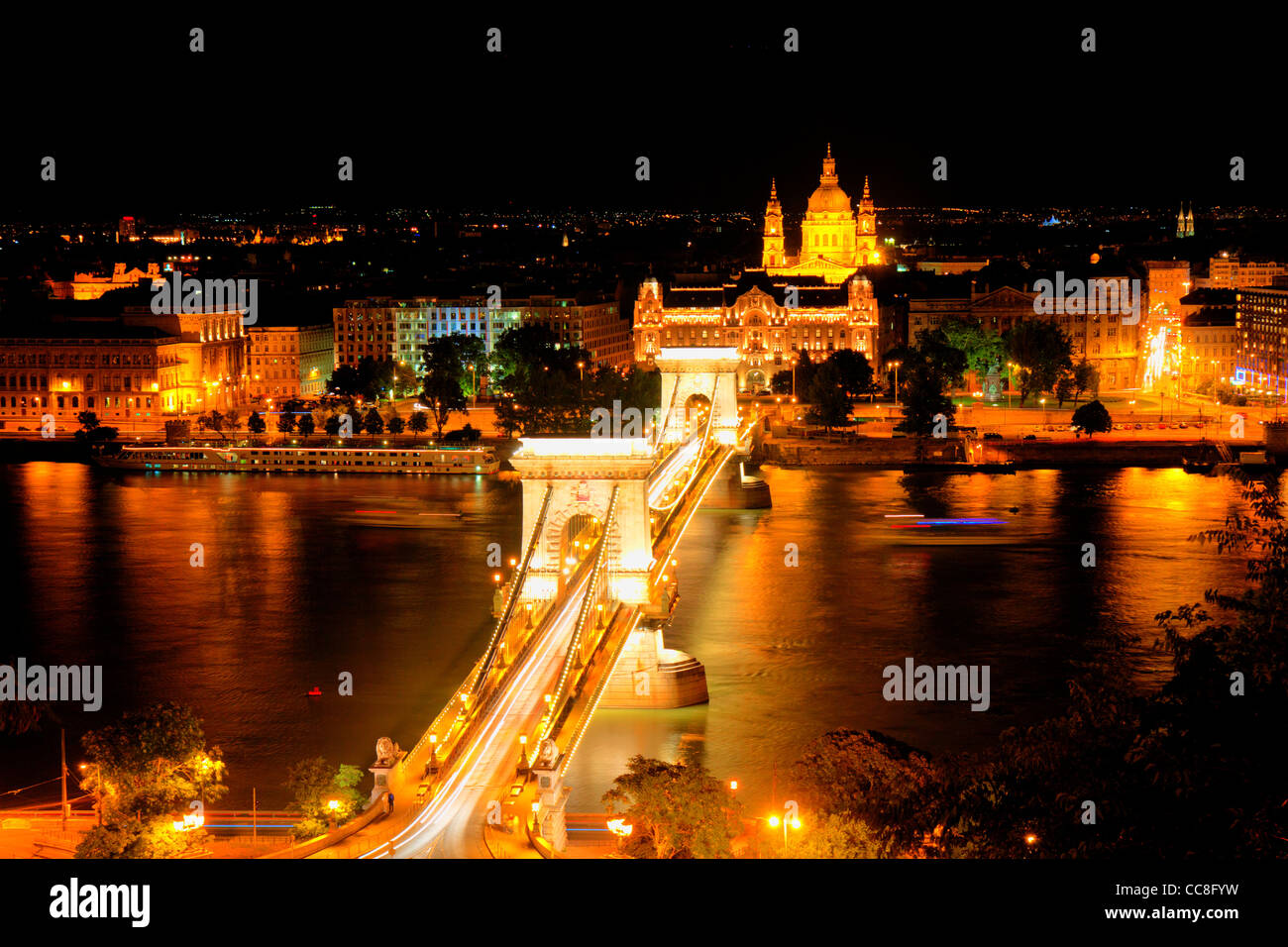 The Széchenyi Chain Bridge (Hungarian: Lánchíd) is a suspension bridge that spans the River Danube between Buda and Pest. Night Stock Photo