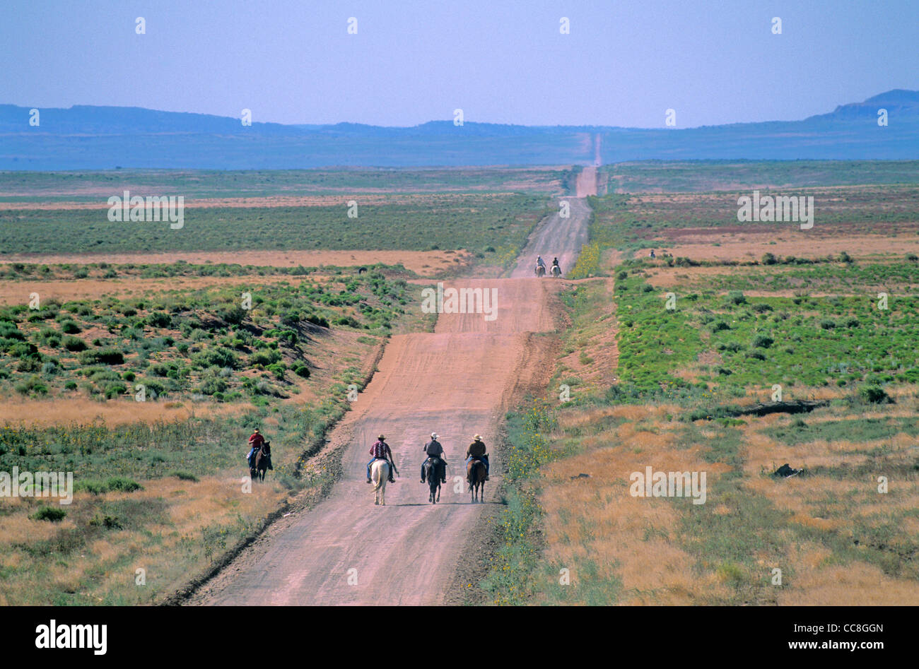 Horseback riders travel on reservation road during 'Water Is Life' ride, near Cottonwood, Navajo Indian Nation, Arizona, USA Stock Photo