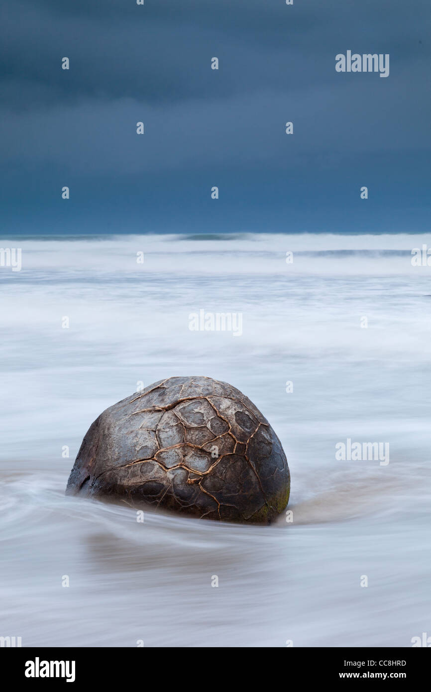 A boulder at Moeraki, Otago, New Zealand, at nightfall, long exposure. Stock Photo