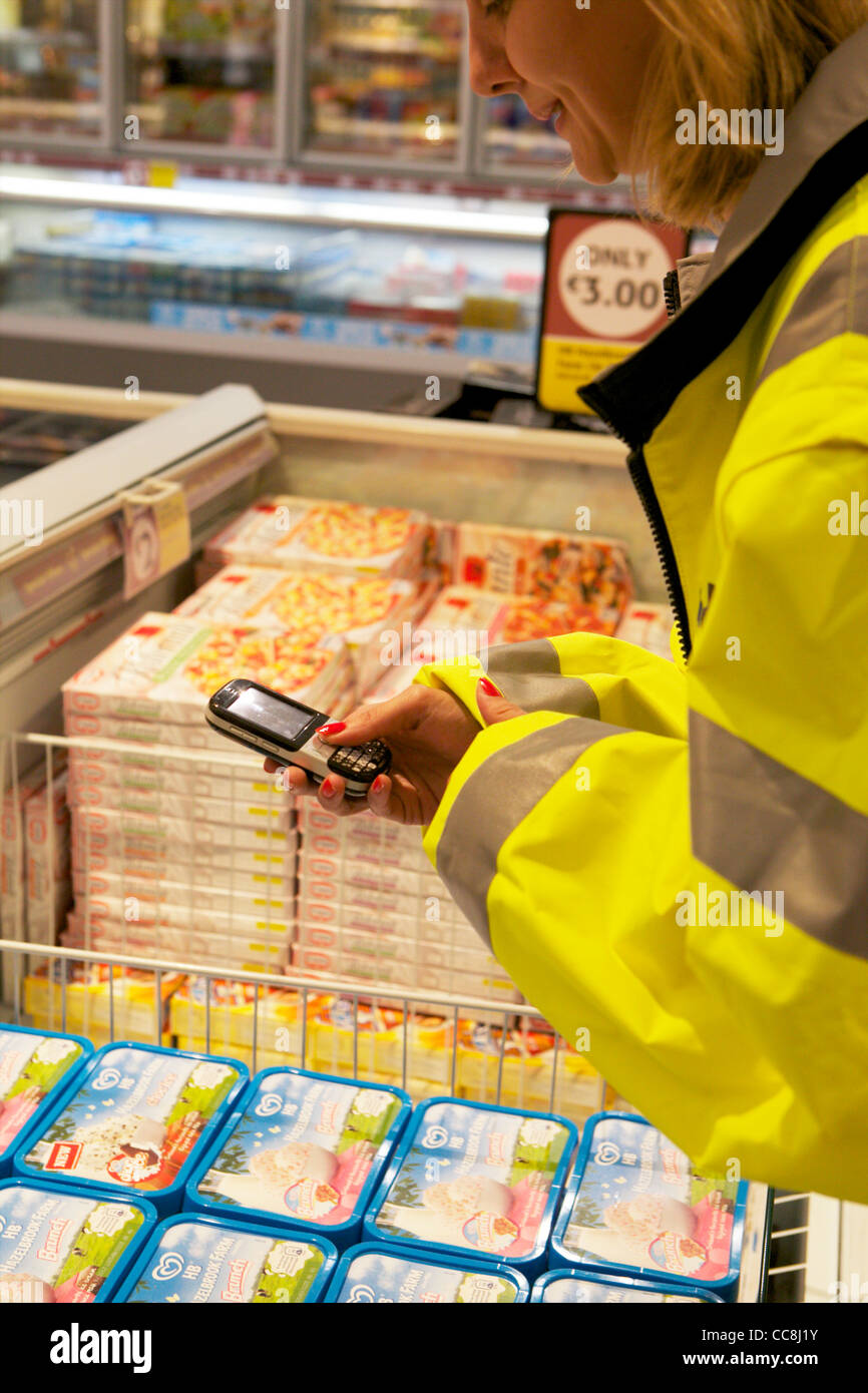 A handheld device doing an in store audit on products on sale Stock Photo