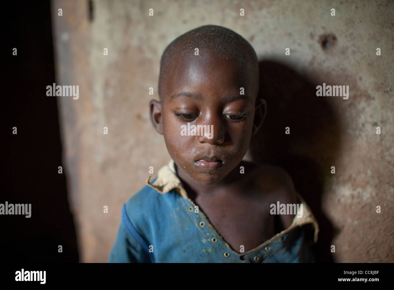 A boy inside his home in Masaka, Uganda, East Africa. Stock Photo