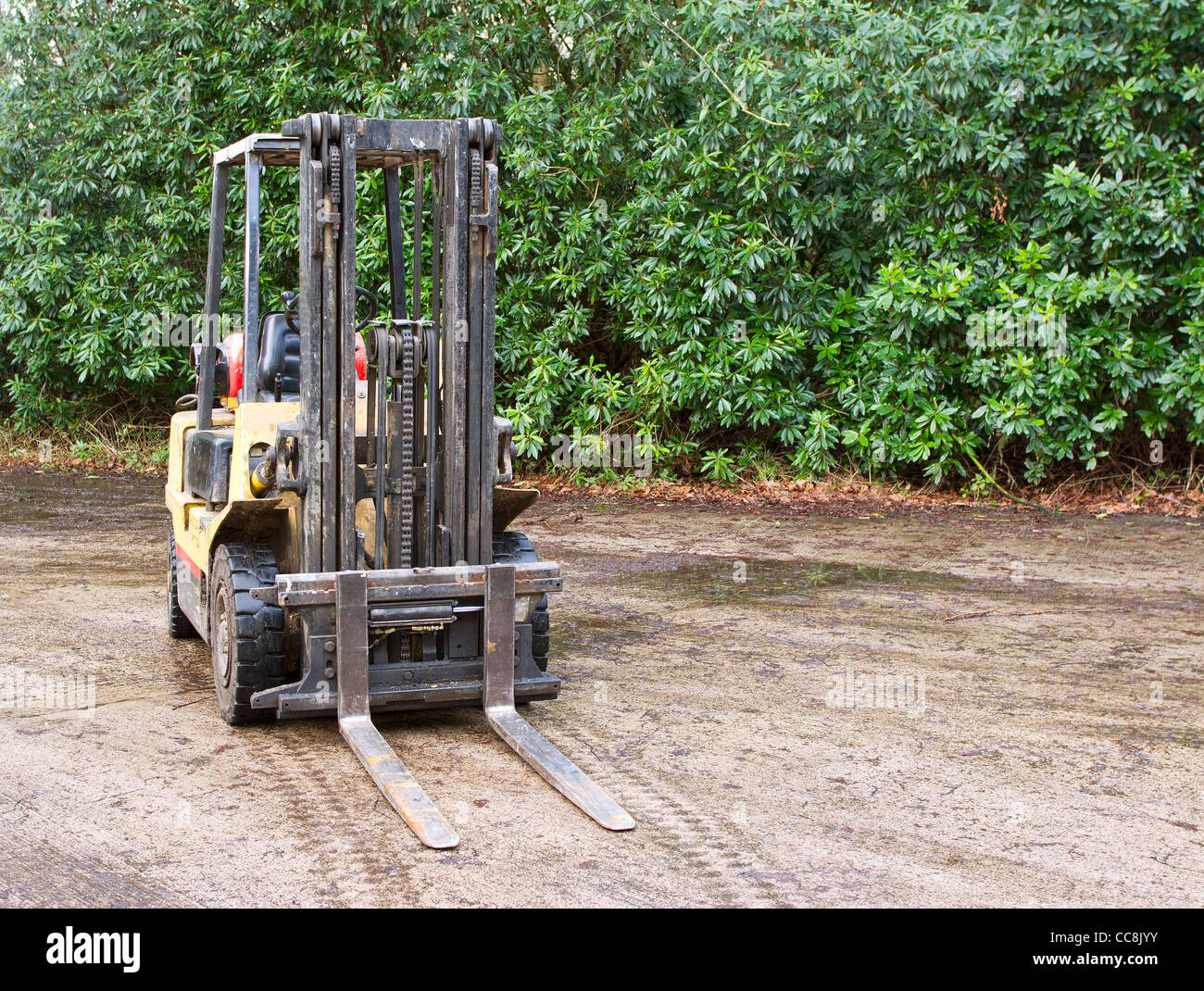 Forklift truck outside on wet concrete Stock Photo