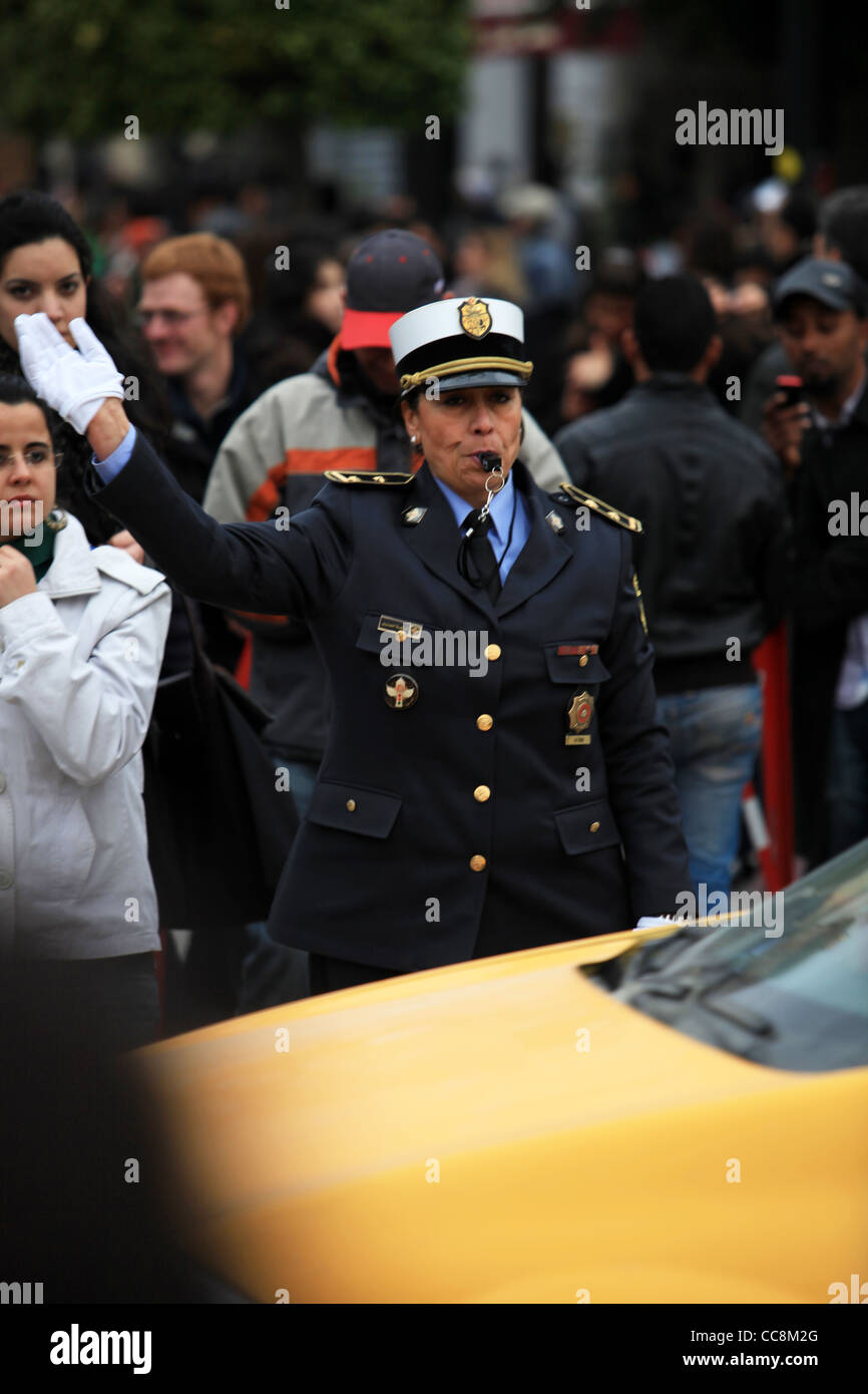 Police officer on duty diverting traffic on Avenue Habib-Bourguiba, after it had been closed due to Tunisian Revolution Annivers Stock Photo