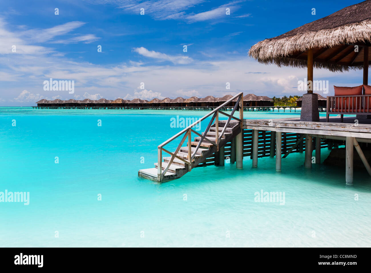 Over water bungalow with steps into amazing blue lagoon Stock Photo