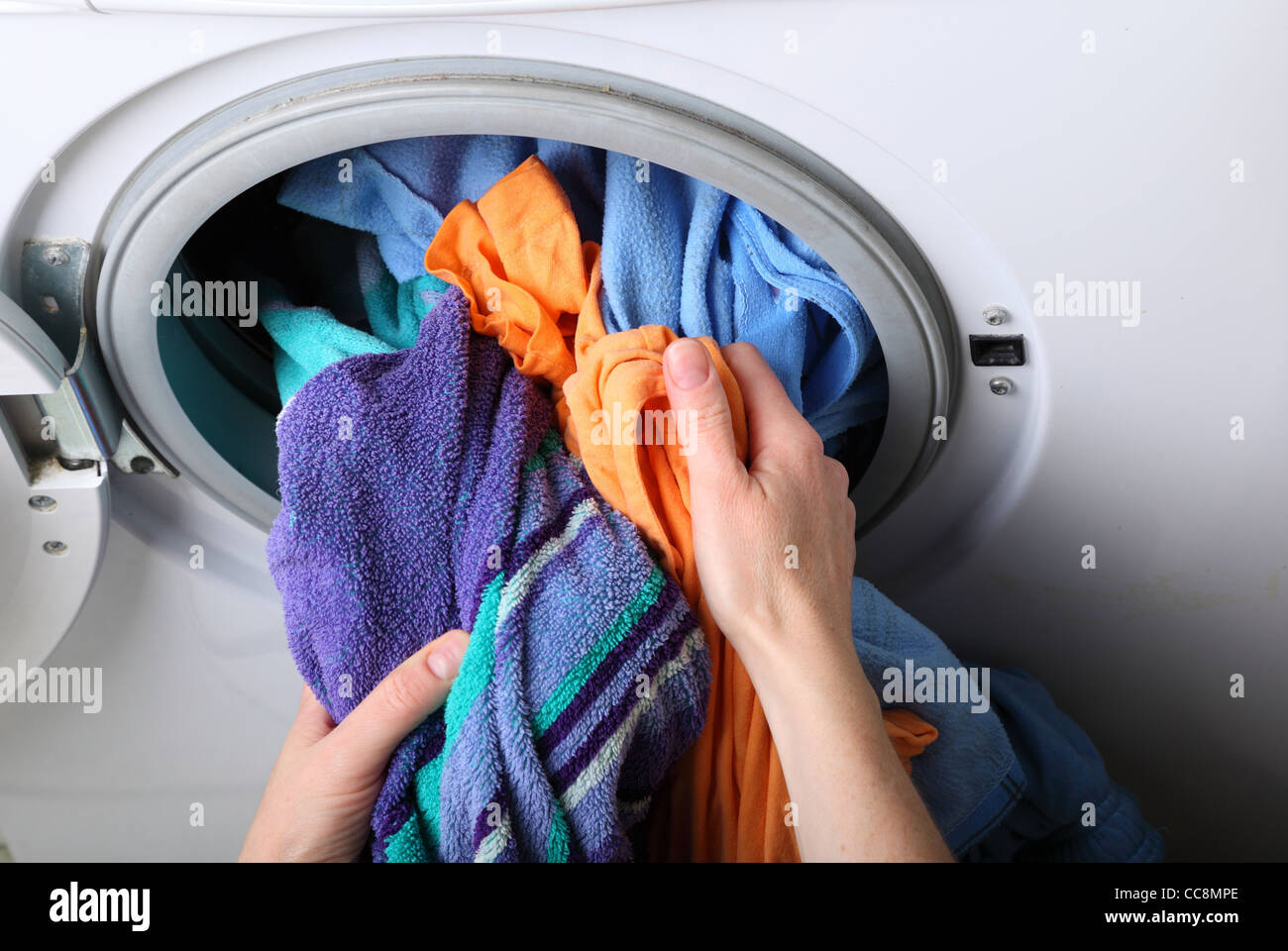 woman loading Preparation washing machine in bathroom clothes in the
