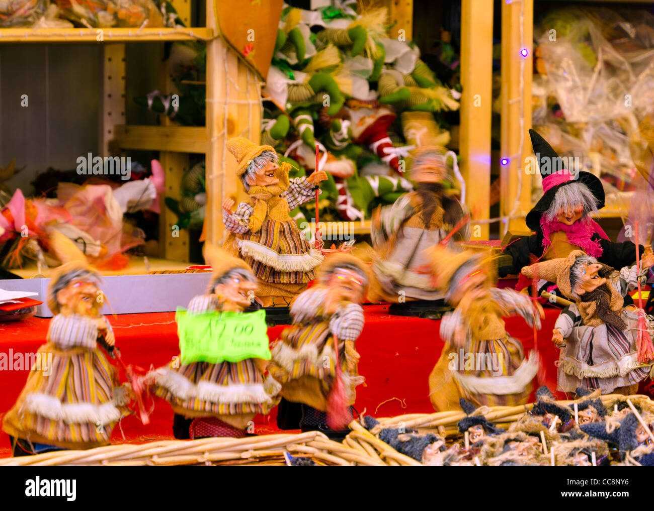 Electronic witch Befana dolls dancing at street market stalls Piazza