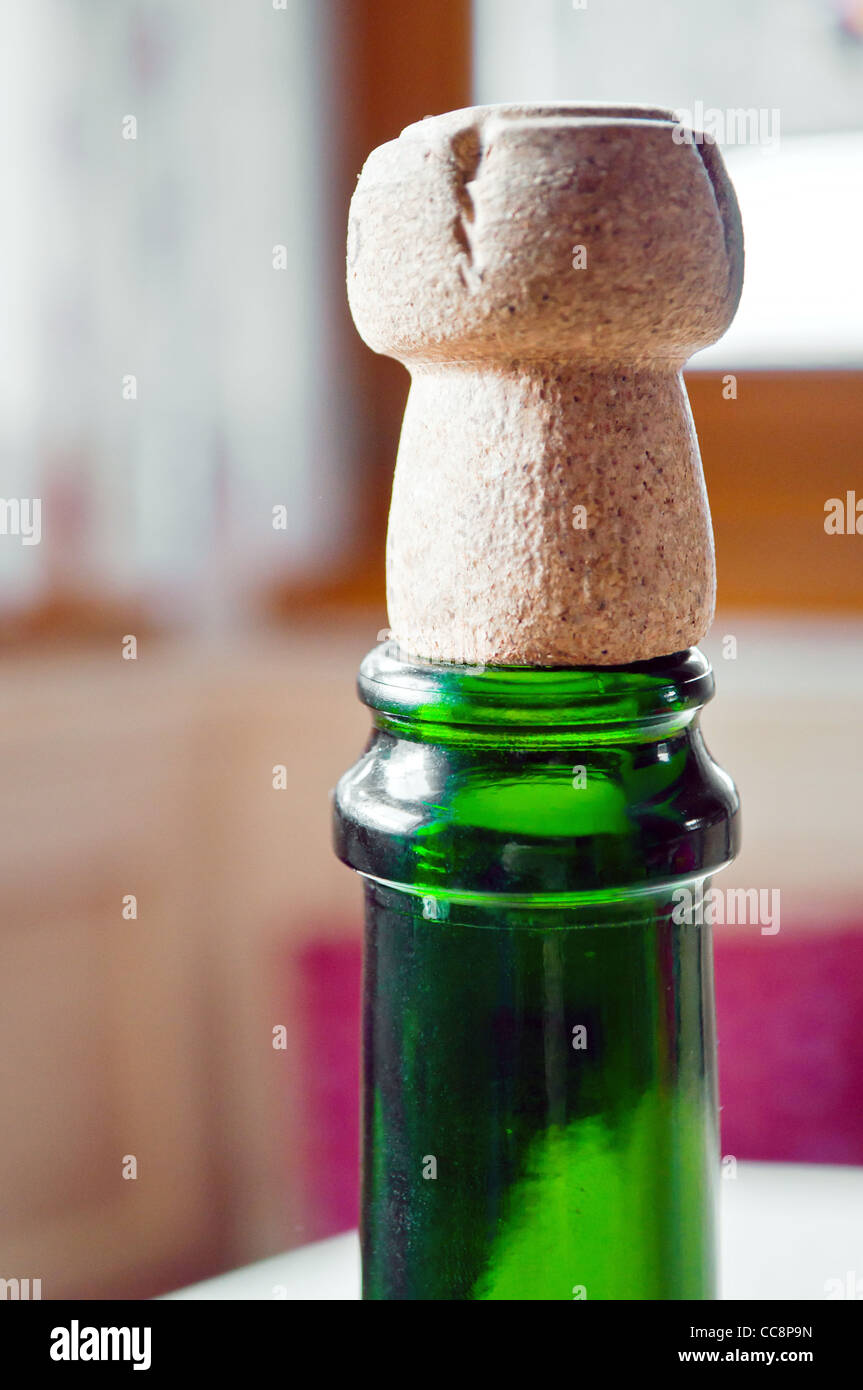 Opened champagne plug over a green bottle Stock Photo Alamy