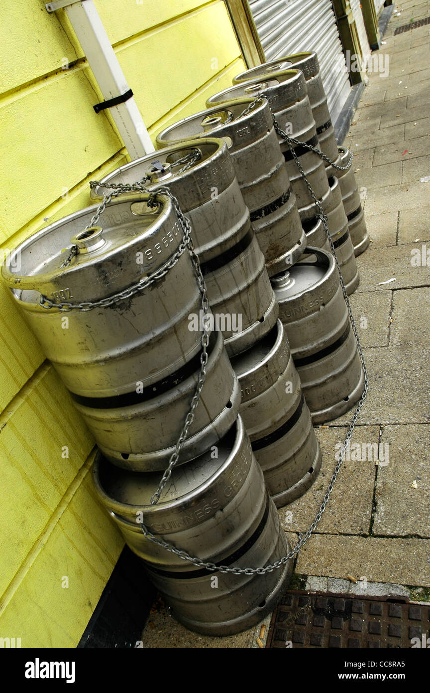 Empty beer kegs secured by chains outside pub in Londonderry, Northern