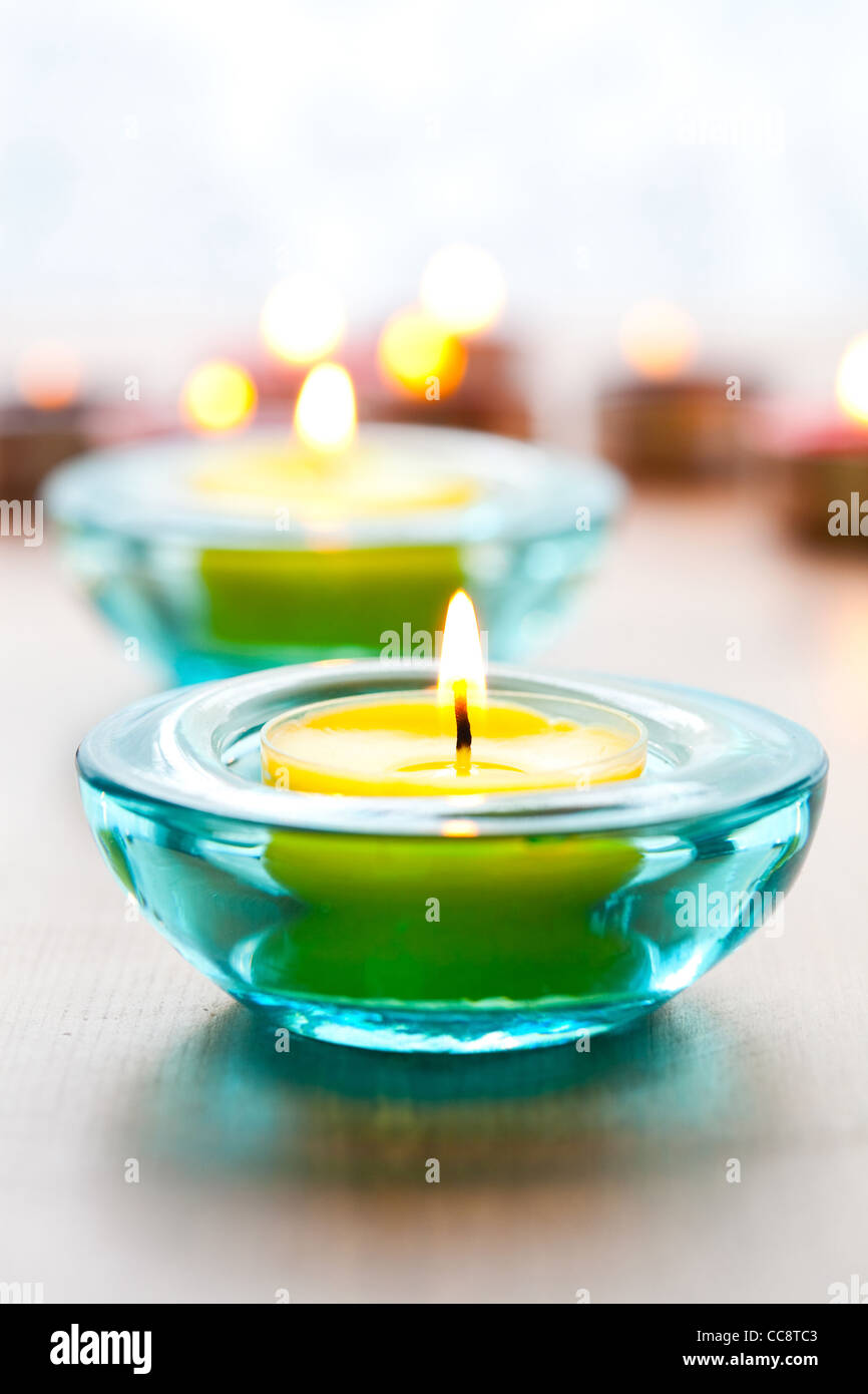 Closeup of yellow candles in blue glass holders Stock Photo Alamy